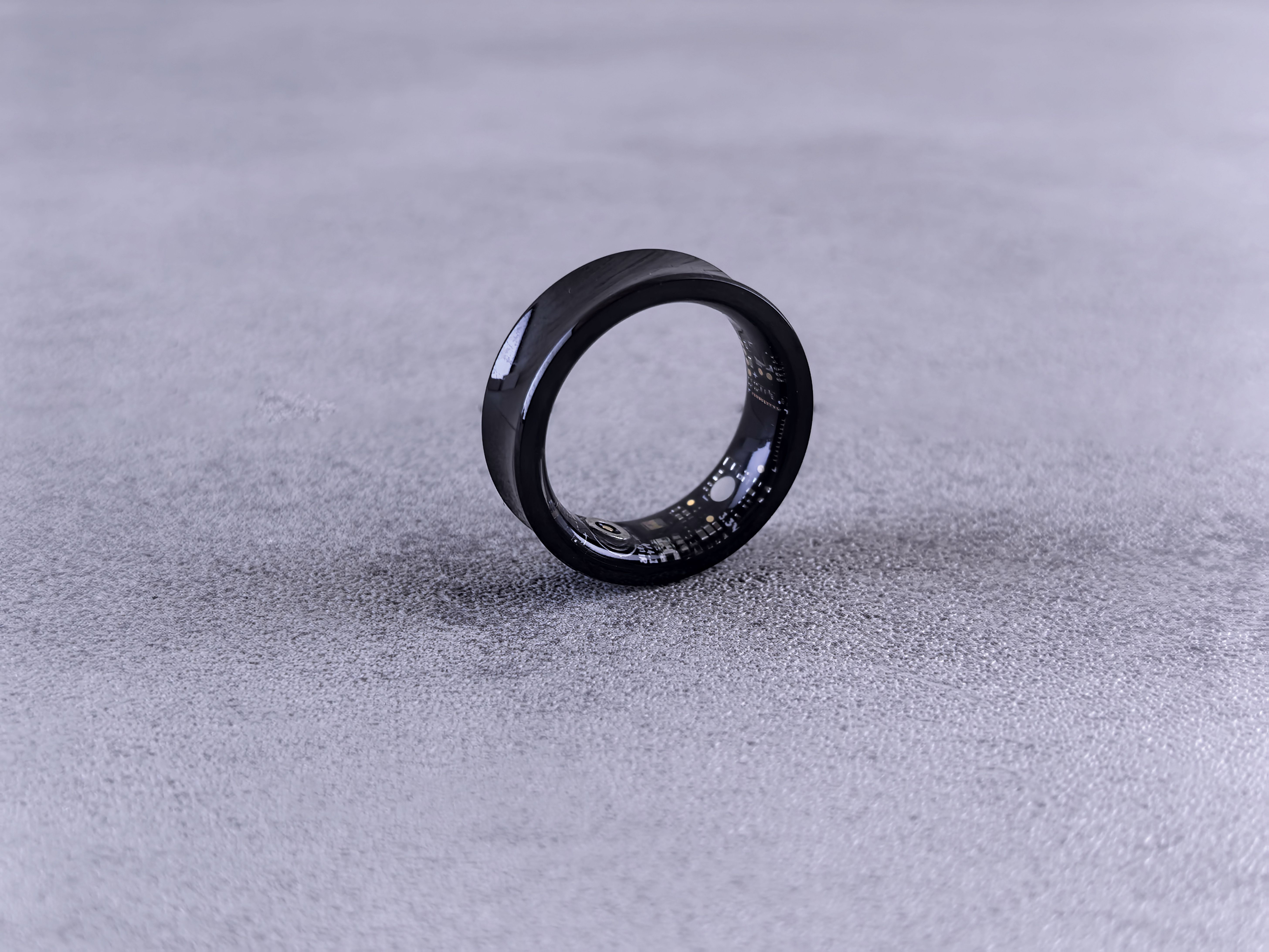 Modern black smart ring with visible sensor detail