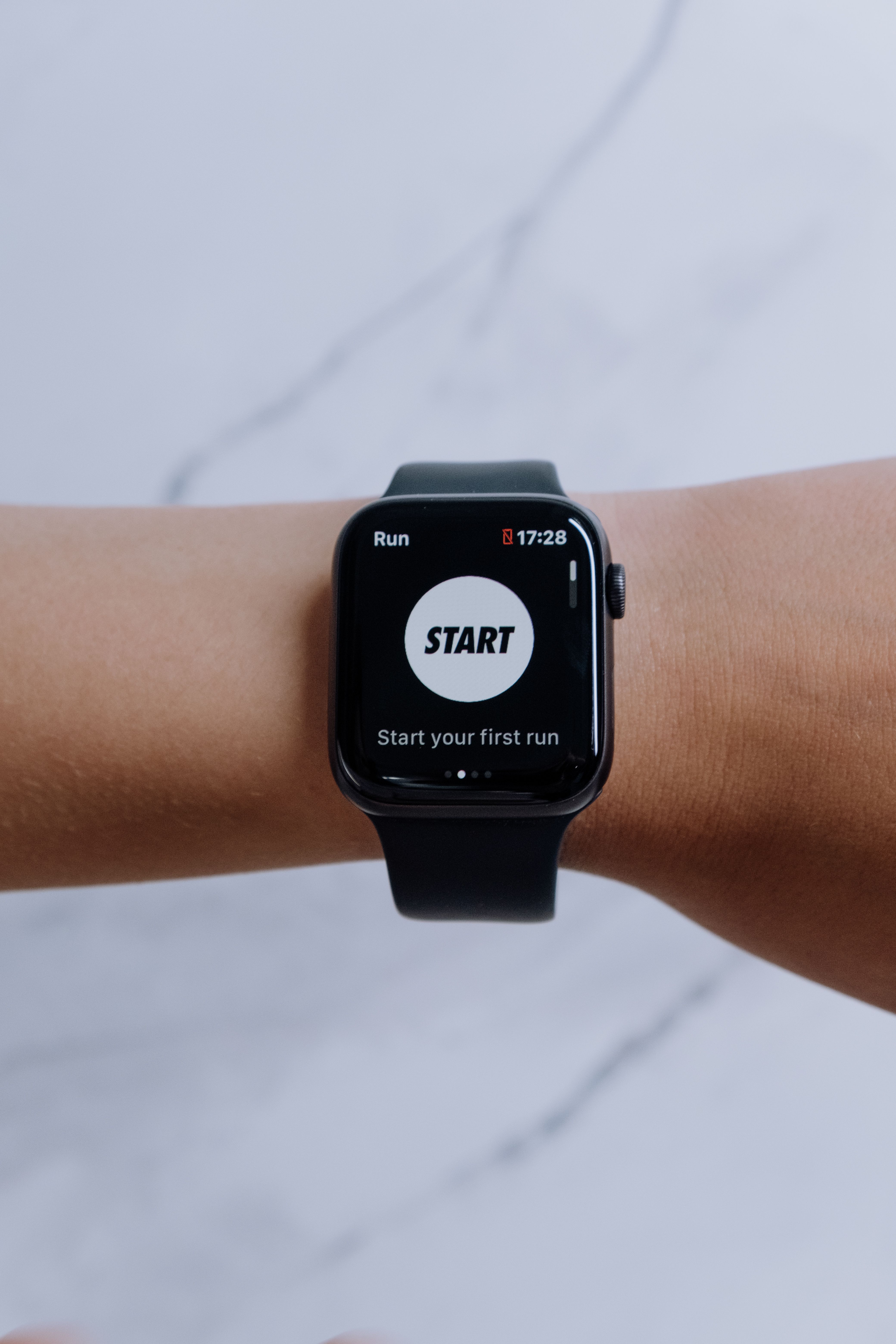 Close-up of a black smartwatch on a wrist showing a fitness tracking app