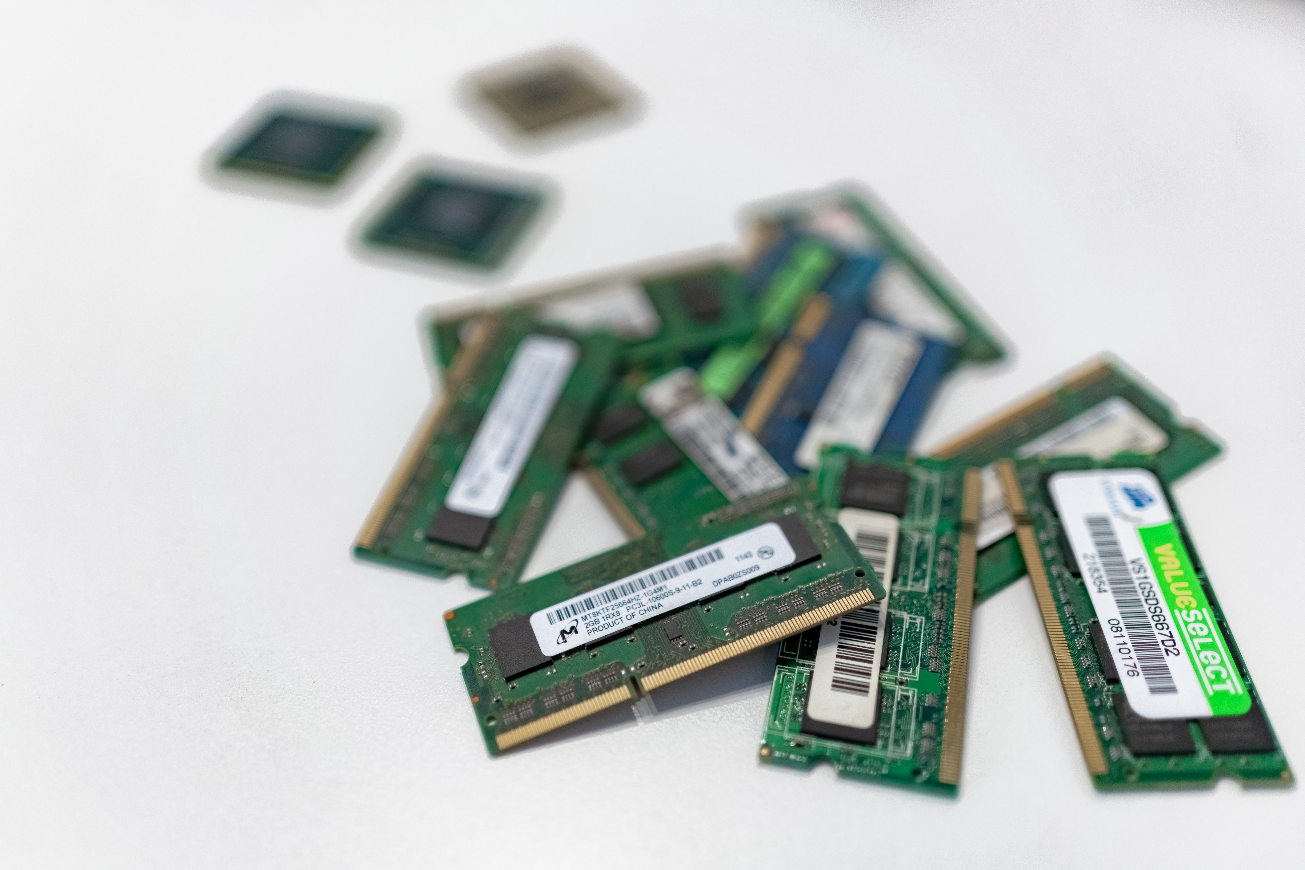 Memory chip modules on a white surface, representing the components behind the 2026 shortage